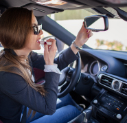 Driver shielding eyes from glare